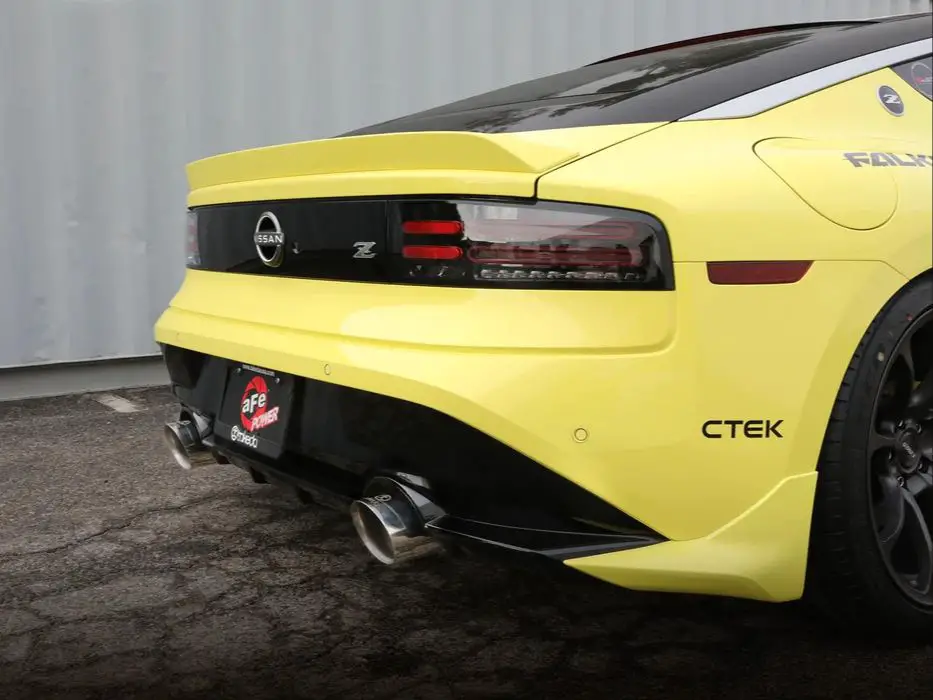 a polished stainless steel catback exhaust system installed on a sports car