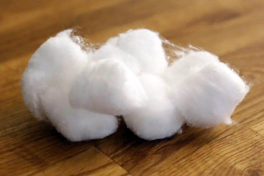 cotton balls soaked in peppermint oil placed along a wall baseboard